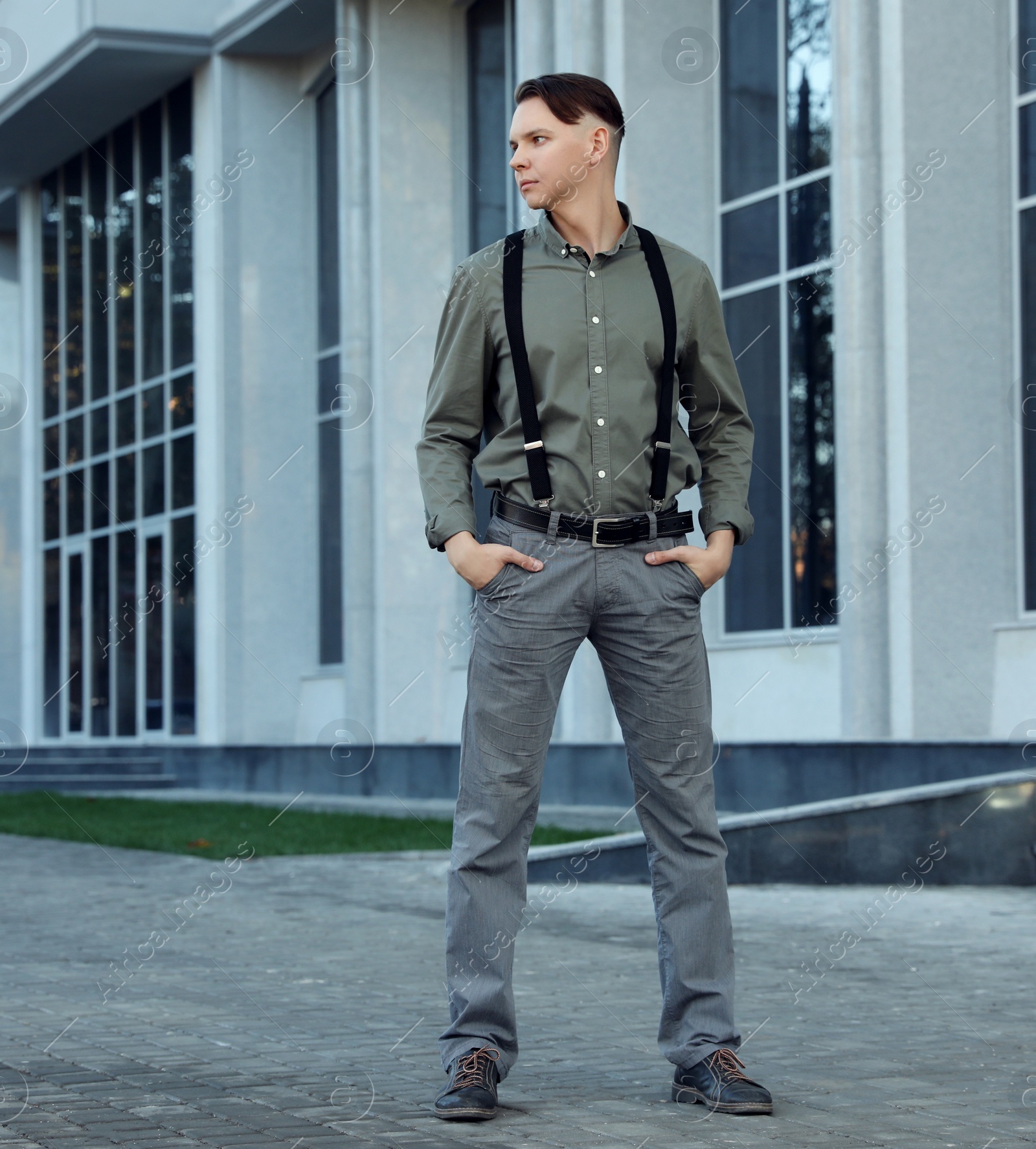 Photo of Portrait of handsome man posing on city street