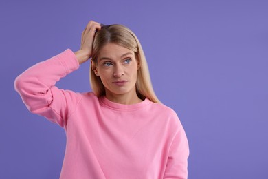 Photo of Portrait of embarrassed woman on purple background