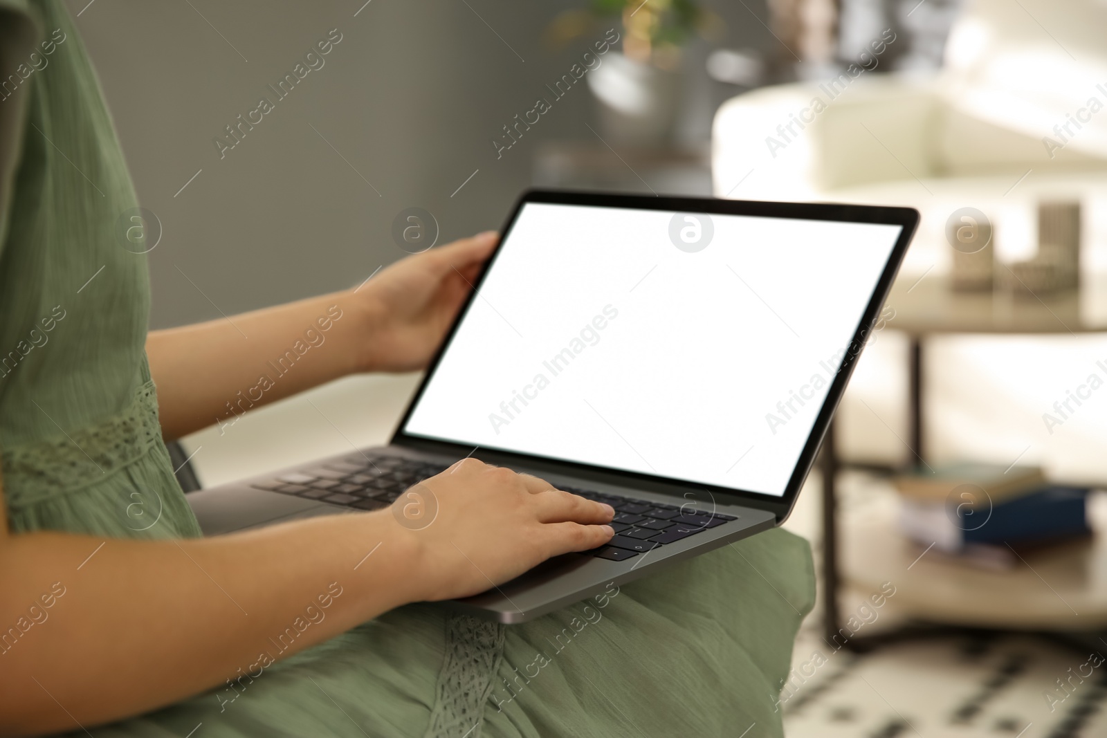 Photo of Woman using laptop at home, closeup. Space for design