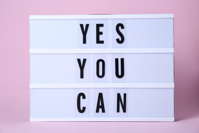 Photo of Lightbox with phrase Yes You Can on pink background. Motivational quote