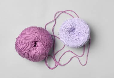 Soft woolen yarns on white background, flat lay