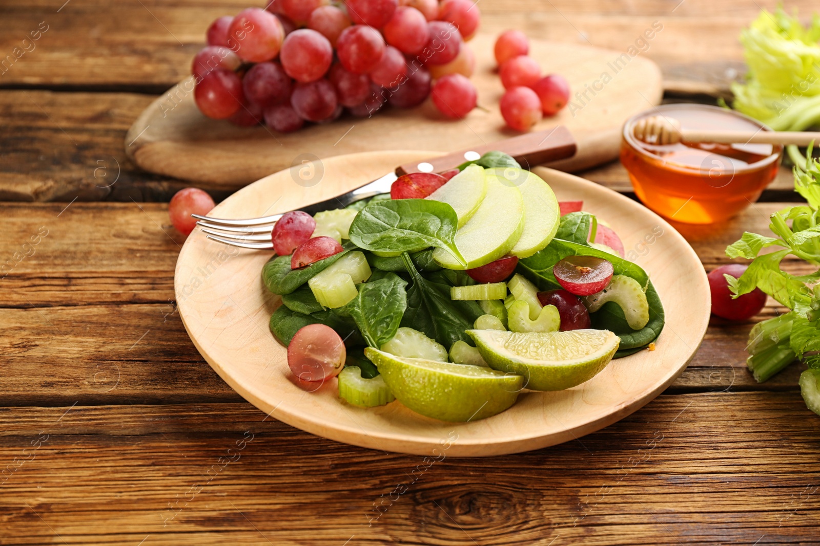 Photo of Delicious fresh celery salad on wooden table