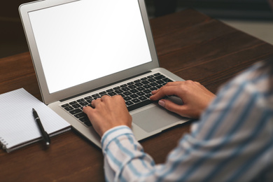 Woman working on modern laptop at table, closeup