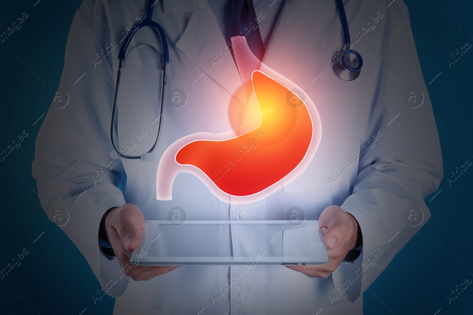 Image of Treatment of heartburn and other gastrointestinal diseases. Doctor using tablet on dark background, closeup. Stomach illustration over device