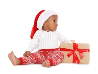 Festively dressed African-American baby with Christmas gifts on white background