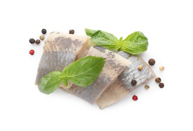 Delicious salted herring slices with basil and peppercorns on white background, top view