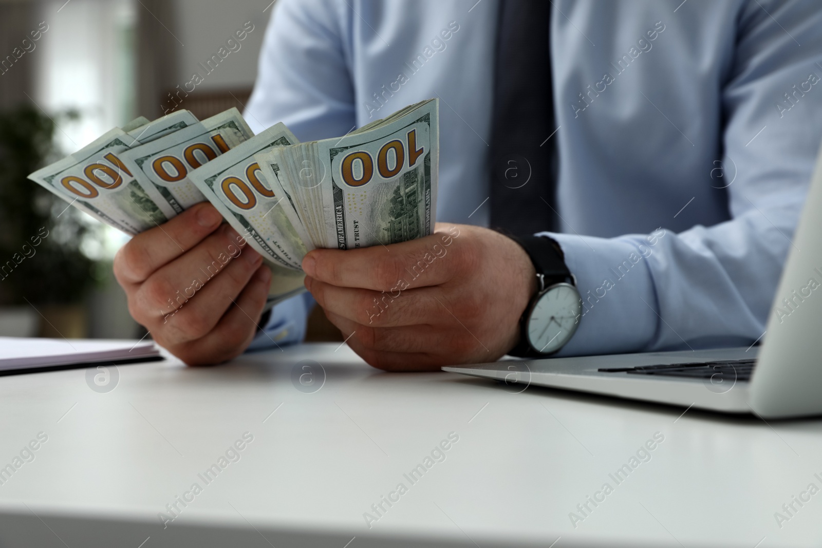 Photo of Cashier counting money at desk in bank, closeup