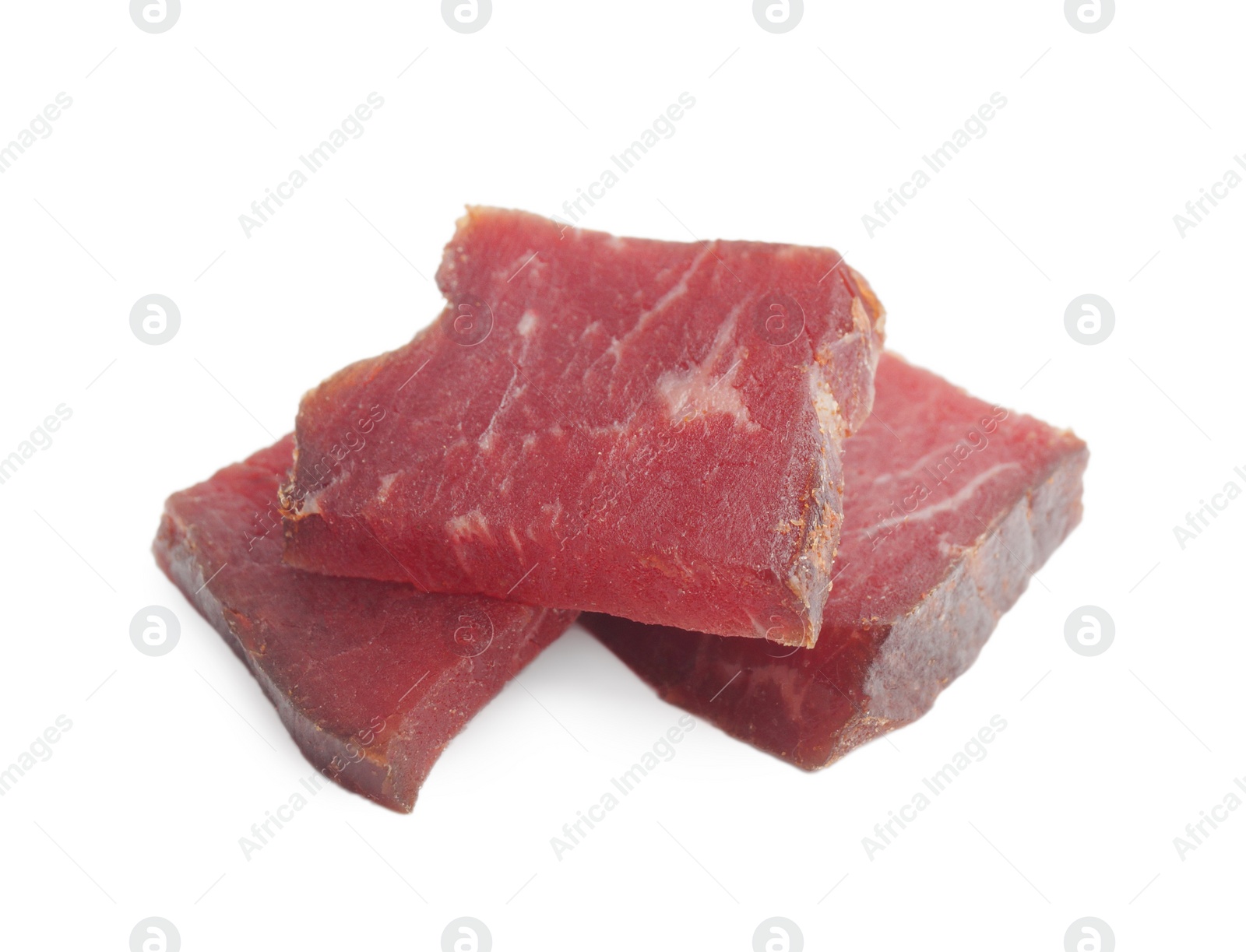 Photo of Pieces of delicious beef jerky on white background