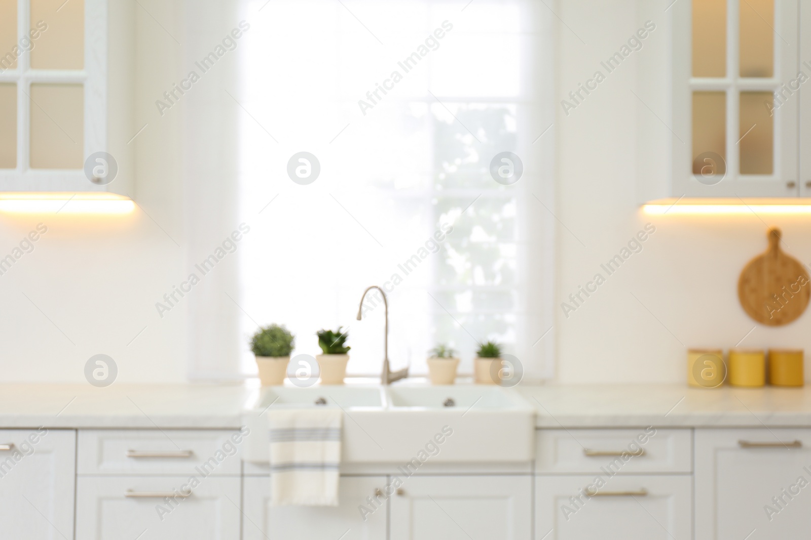 Photo of Blurred view of modern kitchen interior with stylish furniture