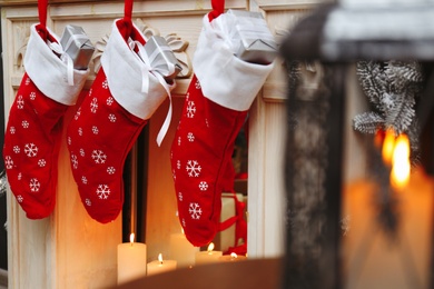 Photo of Fireplace with Christmas stockings in festive room interior