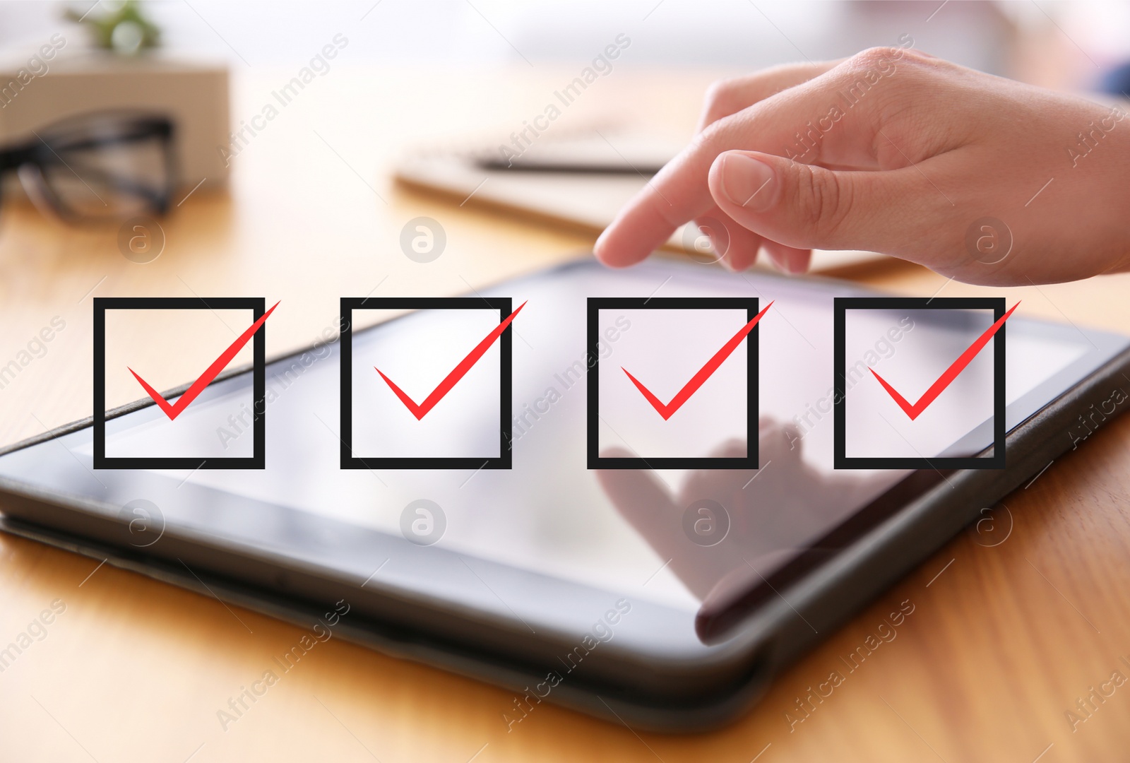 Image of Illustration of check boxes with marks and woman using tablet at wooden table, closeup