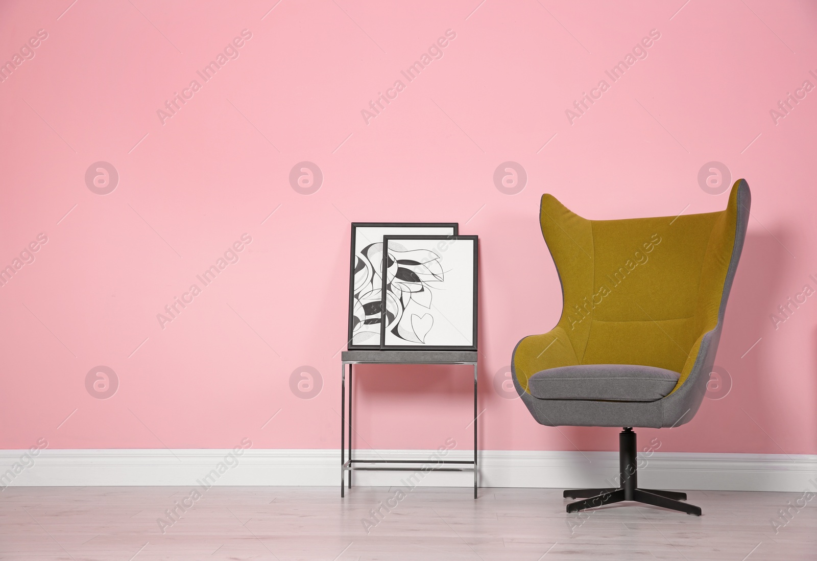 Photo of Comfortable armchair near color wall. Modern interior element