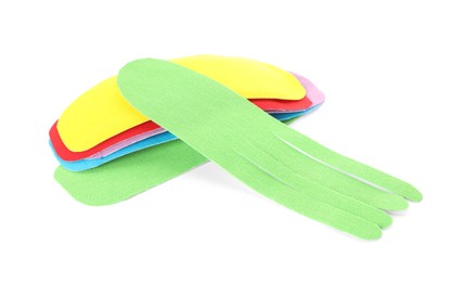 Bright kinesio tape pieces on white background