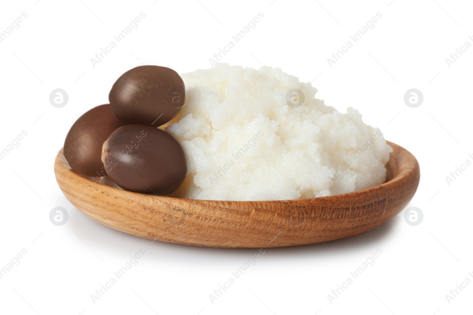 Photo of Shea butter in bowl and nuts isolated on white