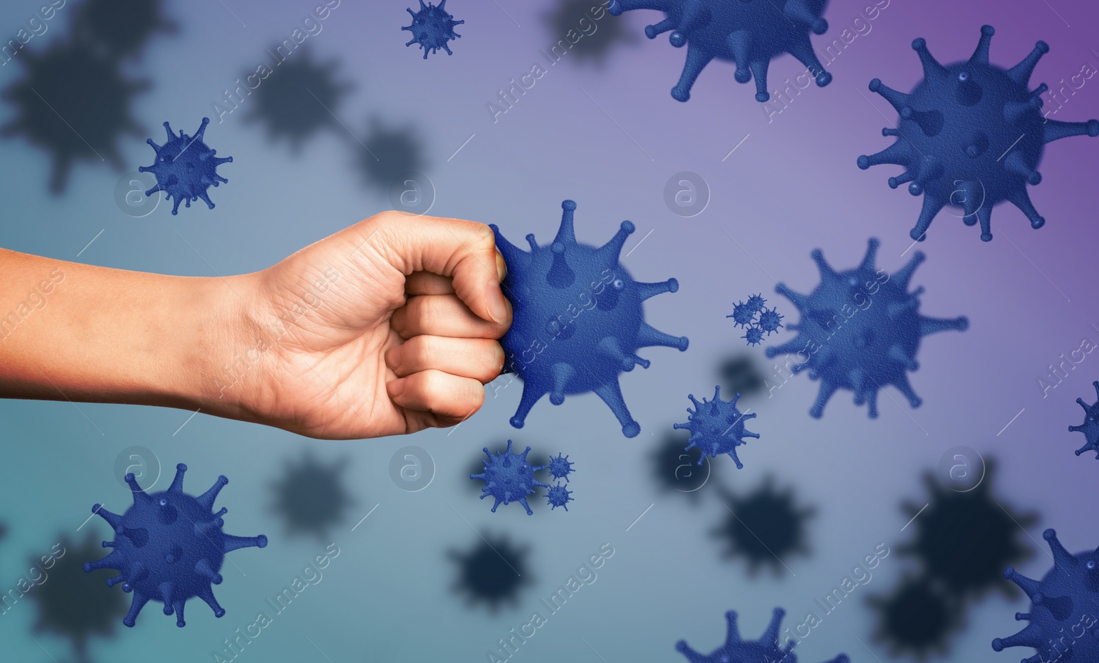 Image of Be healthy - boost your immunity to fight with illness. Man showing clenched fist surrounded by viruses, closeup