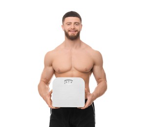 Photo of Portrait of happy athletic man with scales on white background. Weight loss concept