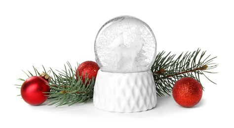 Magical snow globe with pine branches and Christmas balls on white background