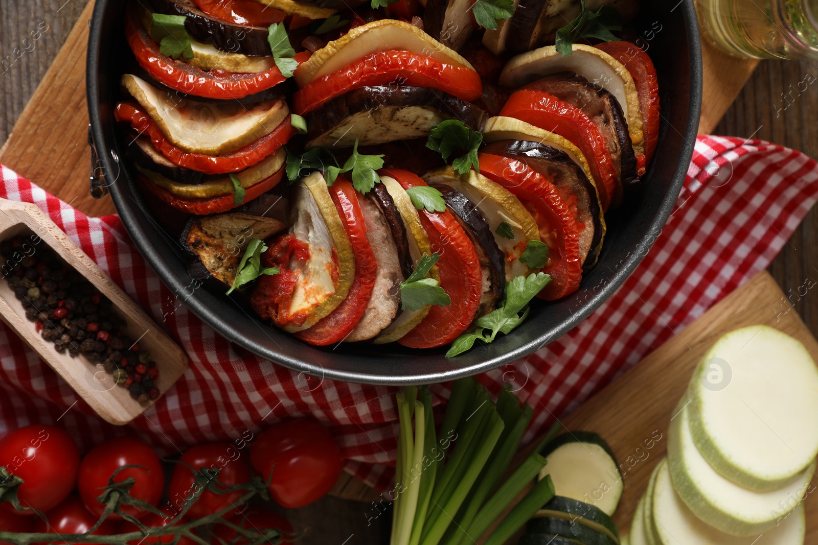 Photo of Delicious ratatouille and ingredients on table, flat lay