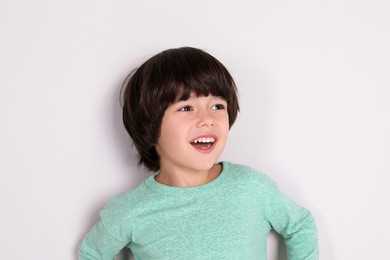 Portrait of cute little boy on white background