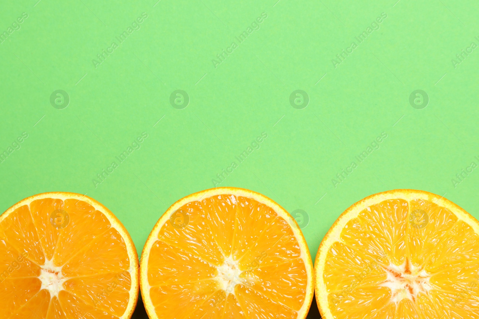 Photo of Flat lay composition with ripe oranges and space for text on color background