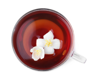 Photo of Cup of tea with fresh jasmine flowers isolated on white, top view