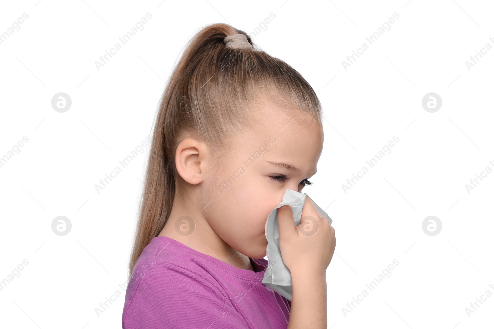 Photo of Sick girl blowing nose in tissue on white background. Cold symptoms