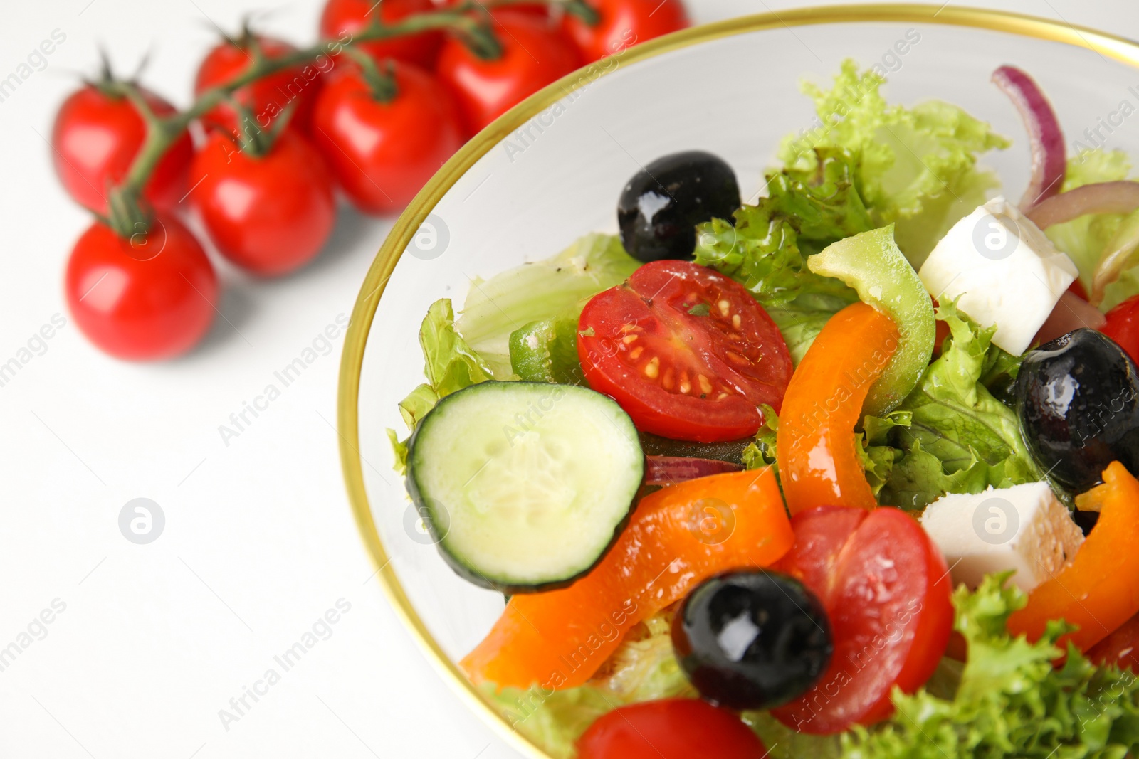 Photo of Tasty fresh Greek salad on white table, closeup