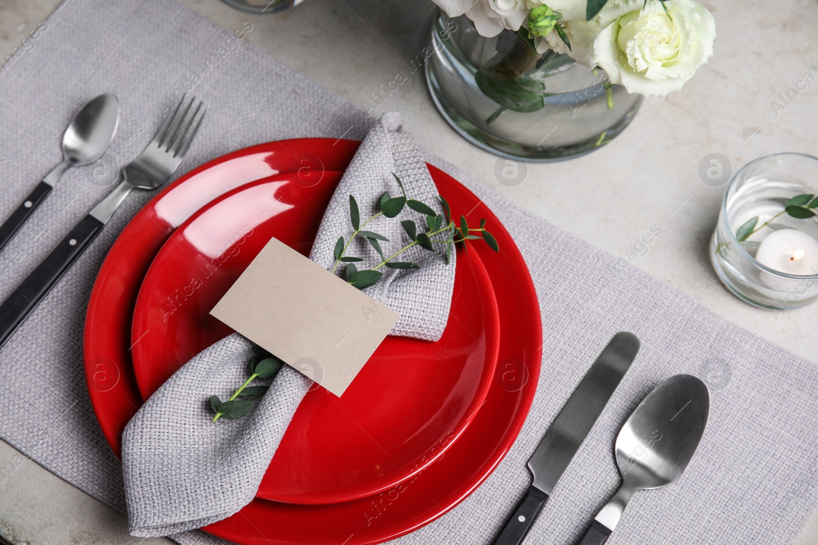 Photo of Elegant festive table setting with blank card on grey background