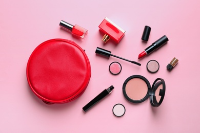 Photo of Makeup products with cosmetic bag on color background