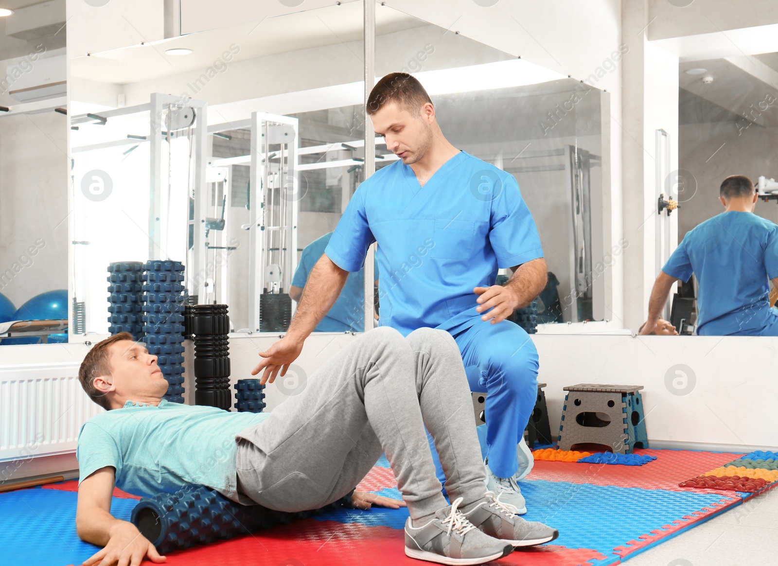 Photo of Patient exercising under physiotherapist supervision in rehabilitation center