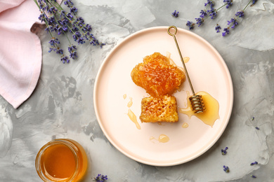 Photo of Flat lay composition with tasty honey combs on light grey table