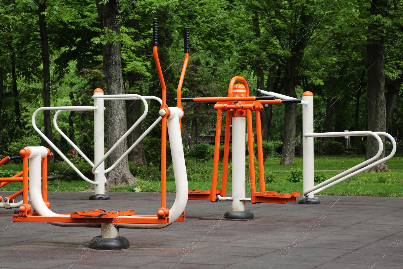 Photo of Empty outdoor gym with double abductor, push up bars and ovate stepper