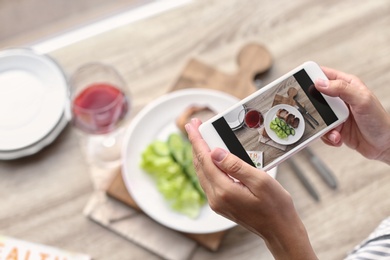 Photo of Blogger taking photo of food with mobile phone, closeup. Space for text