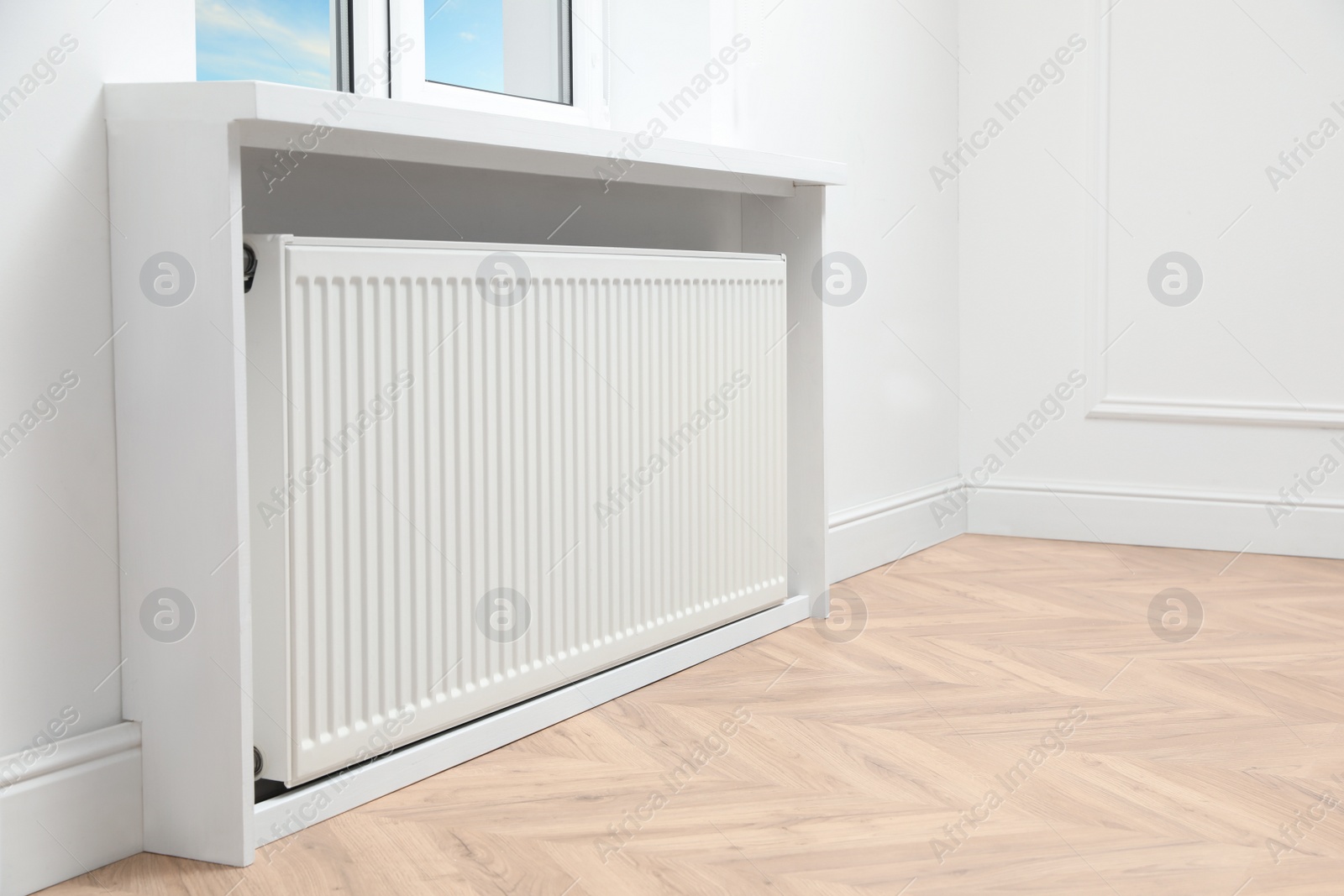 Photo of Modern radiator at home, space for text. Central heating system