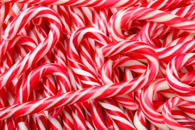 Many sweet Christmas candy canes as background, closeup