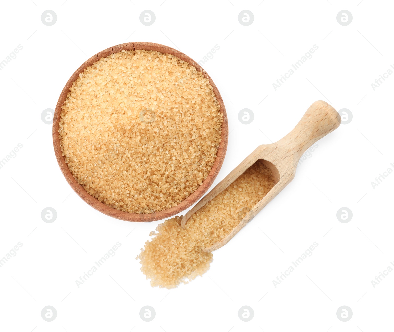 Photo of Wooden bowl and scoop of granulated brown sugar on white background, top view