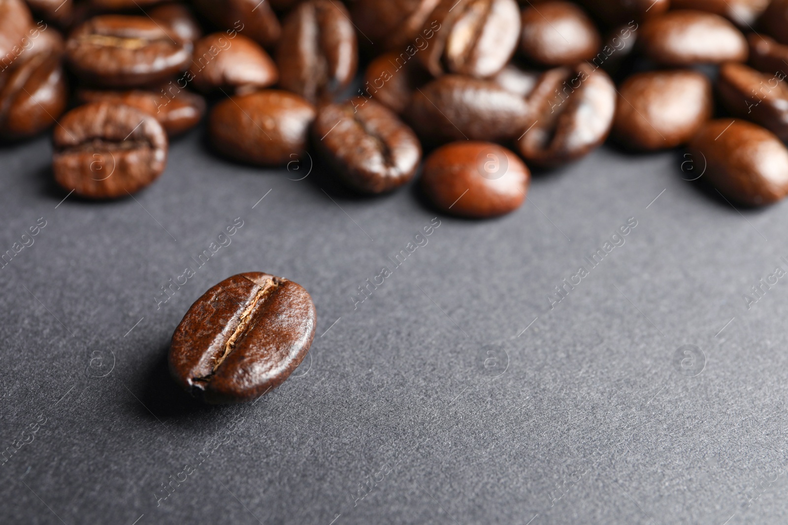 Photo of Roasted coffee beans on grey background, closeup