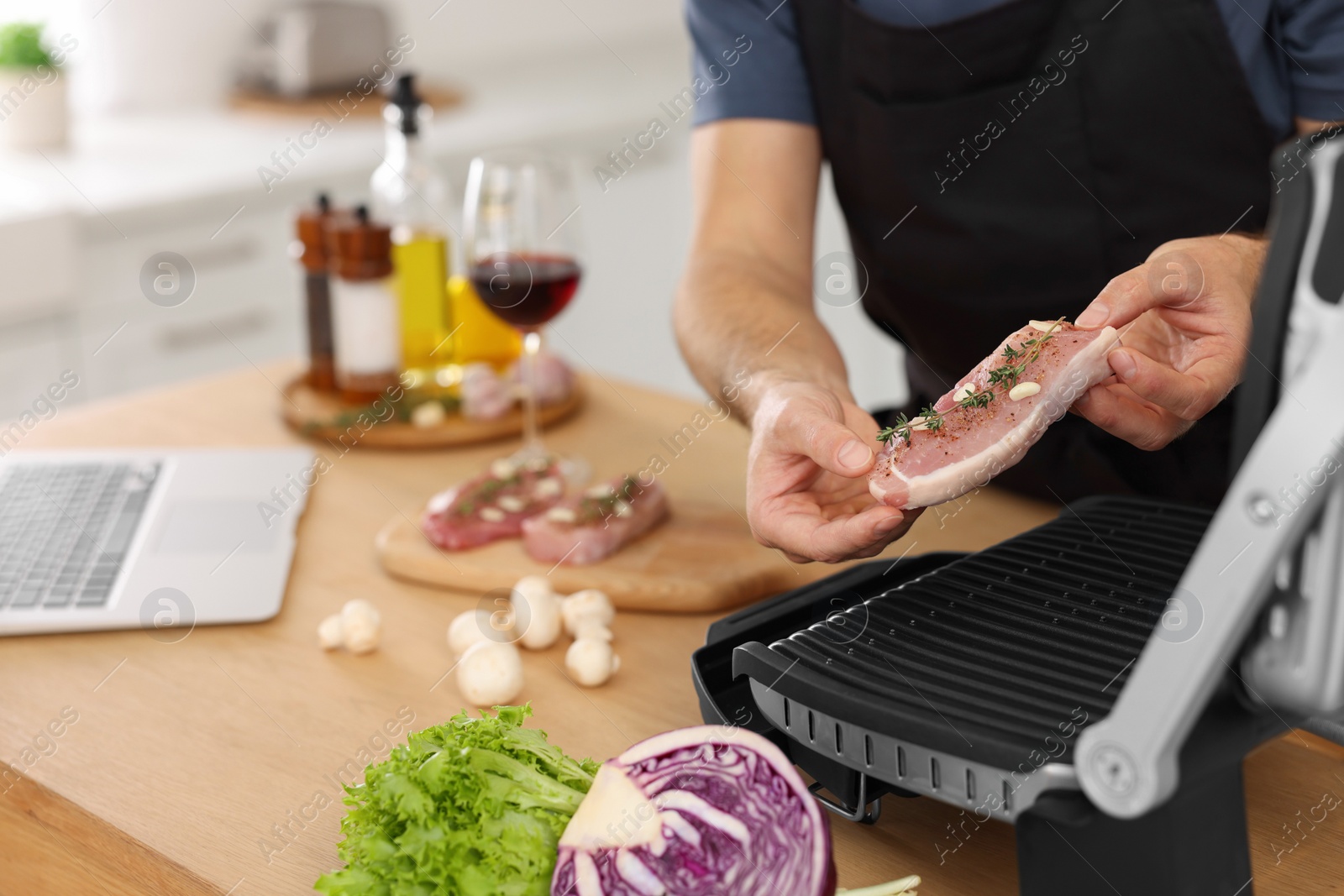 Photo of Man making dinner in kitchen, closeup. Online cooking course