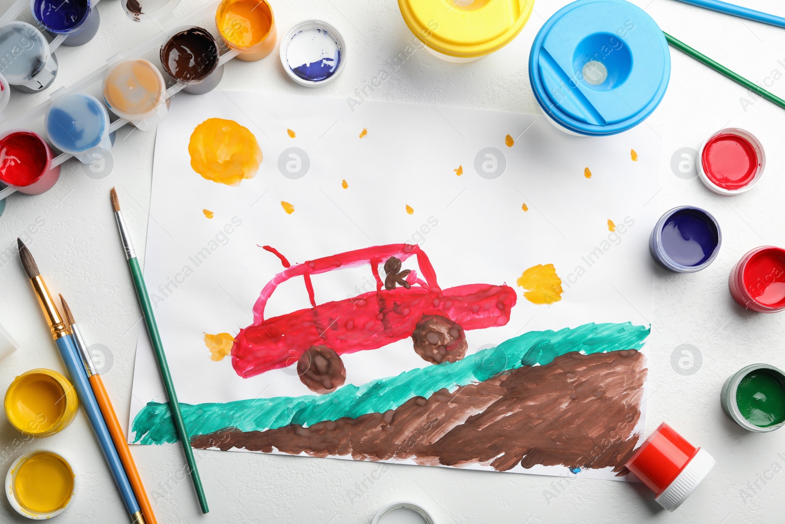 Photo of Flat lay composition with child's painting of car on white table