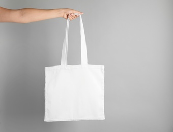 Woman with tote bag on grey background. Mock up for design