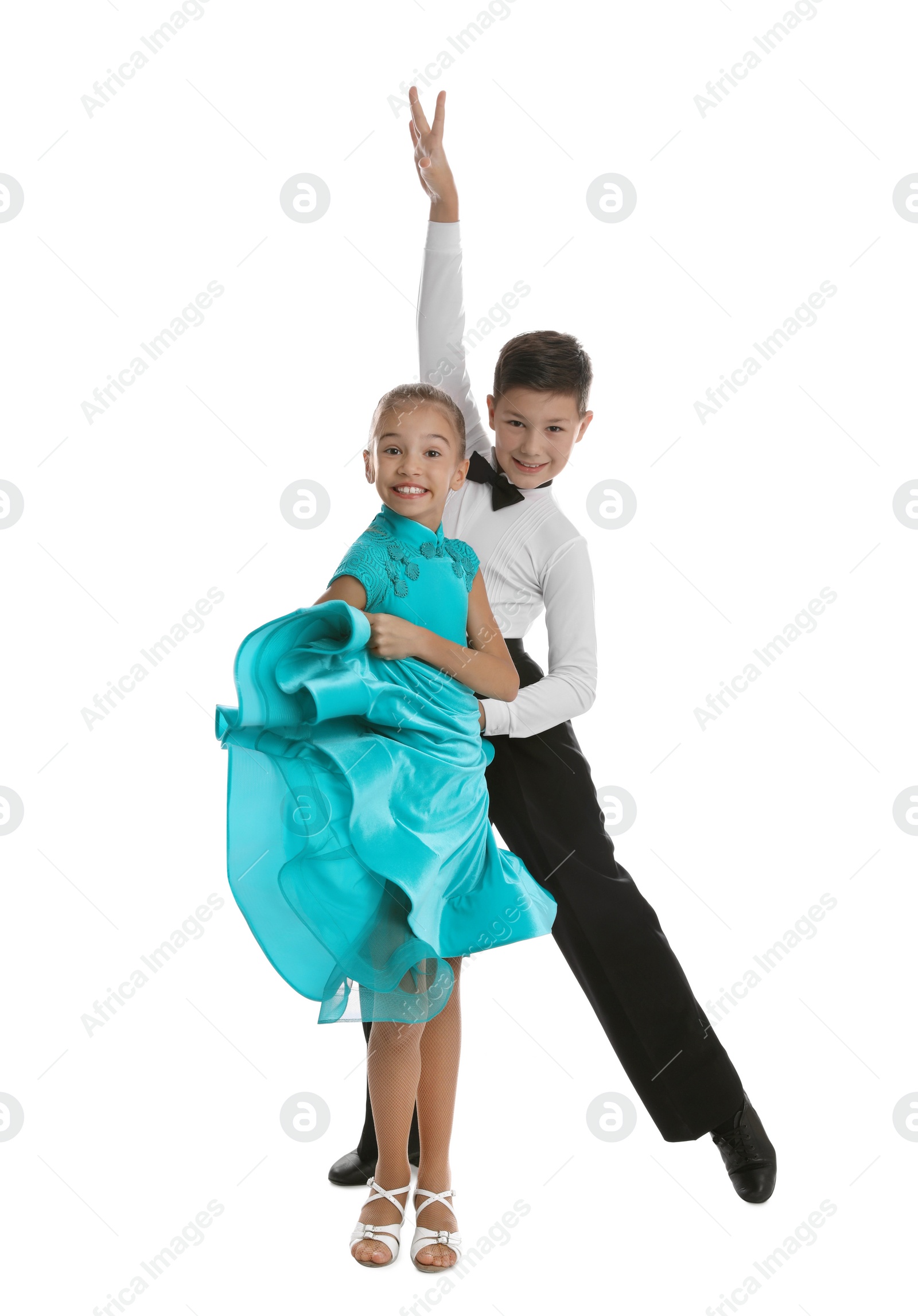 Photo of Beautifully dressed couple of kids dancing on white background