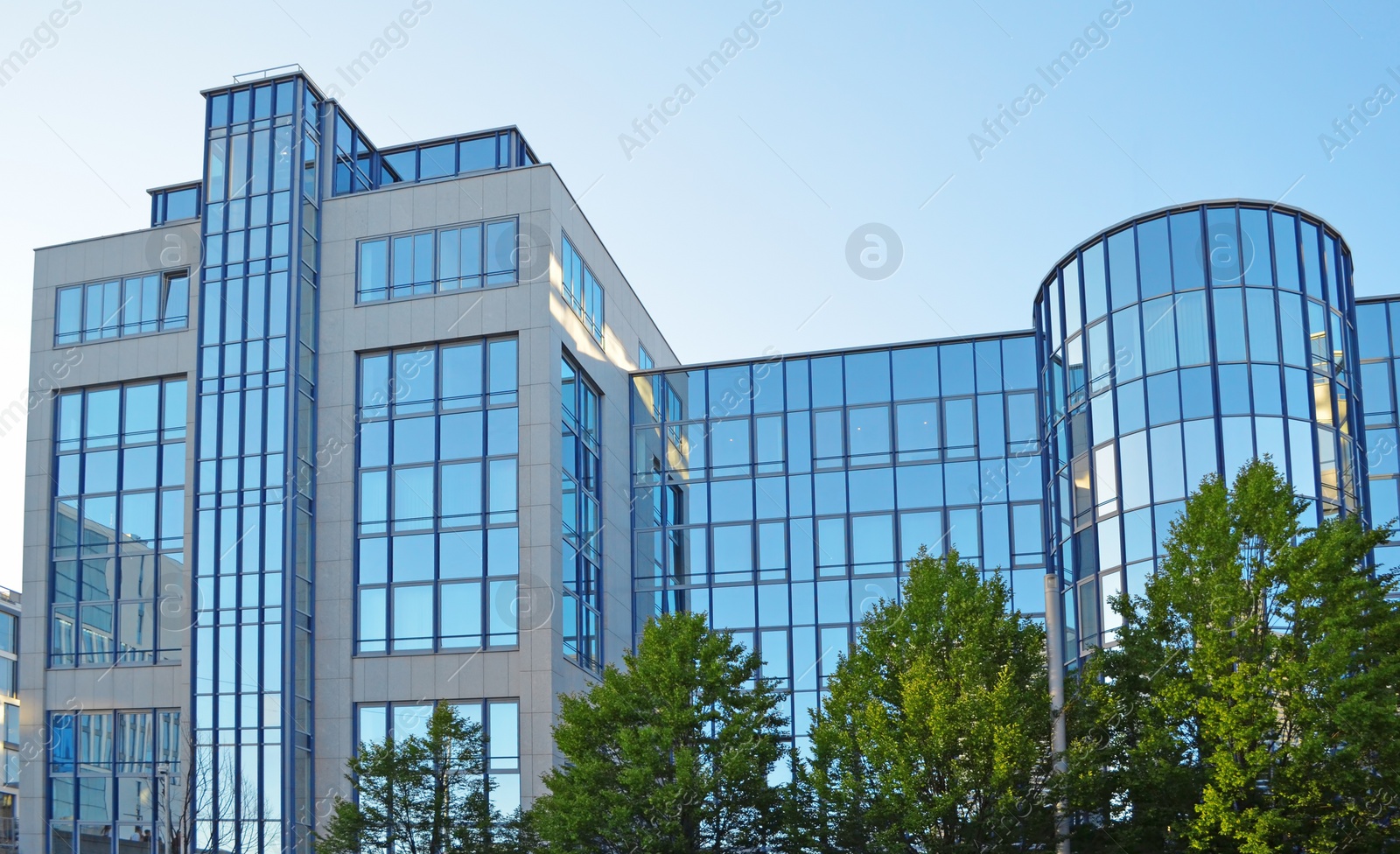 Photo of MUNICH, GERMANY - JUNE 23, 2018: Office building with many tinted windows on sunny day