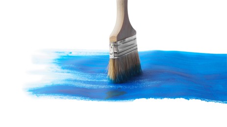 Blue paint stroke and brush on white background