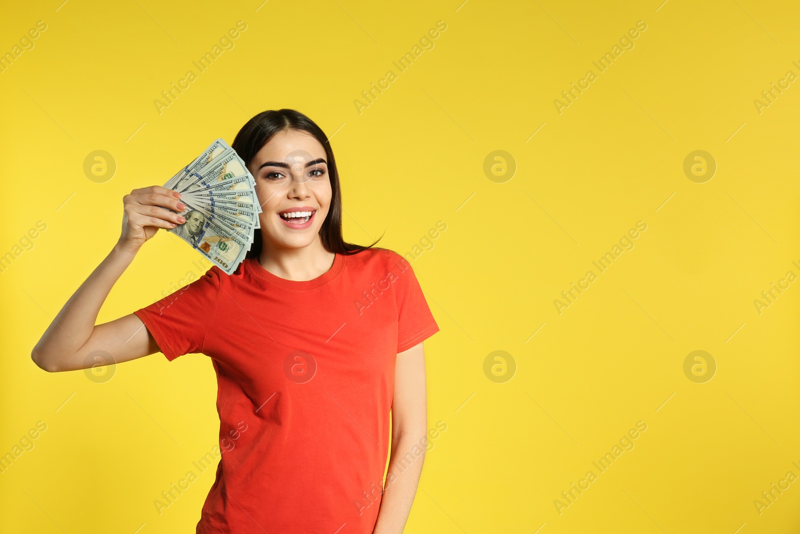 Photo of Young woman with money on color background. Space for text