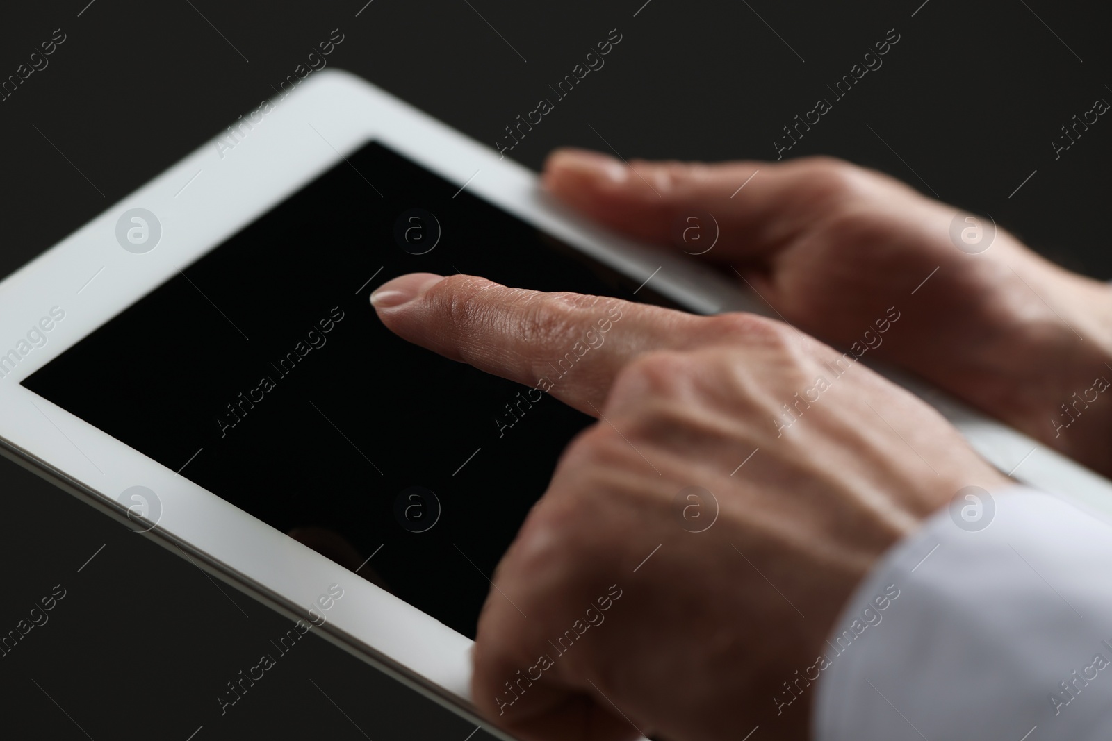 Photo of Closeup view of man using new tablet indoors