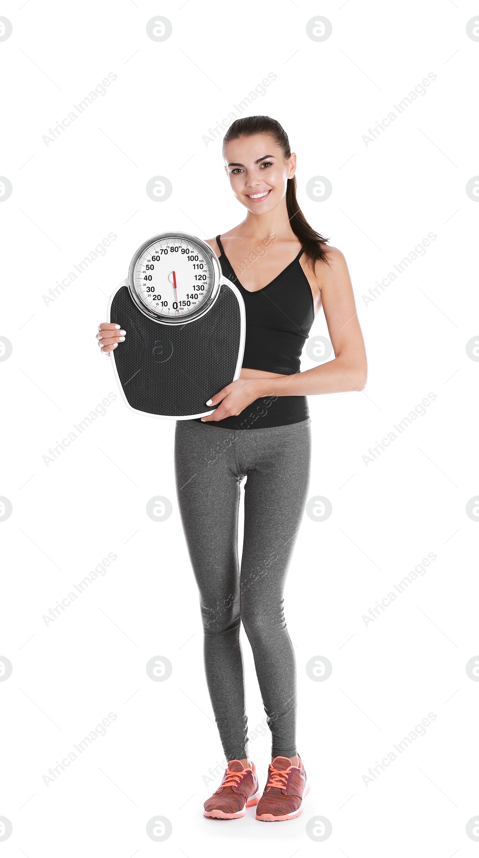 Photo of Happy young woman with scales on white background. Weight loss motivation