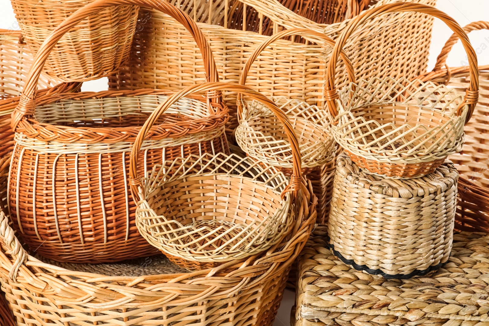 Photo of Many different wicker baskets made of natural material as background