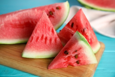 Photo of Yummy watermelon slices on wooden board, closeup