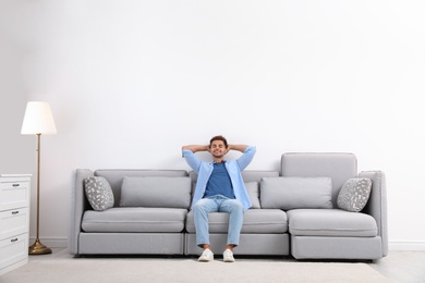 Young man relaxing on sofa at home