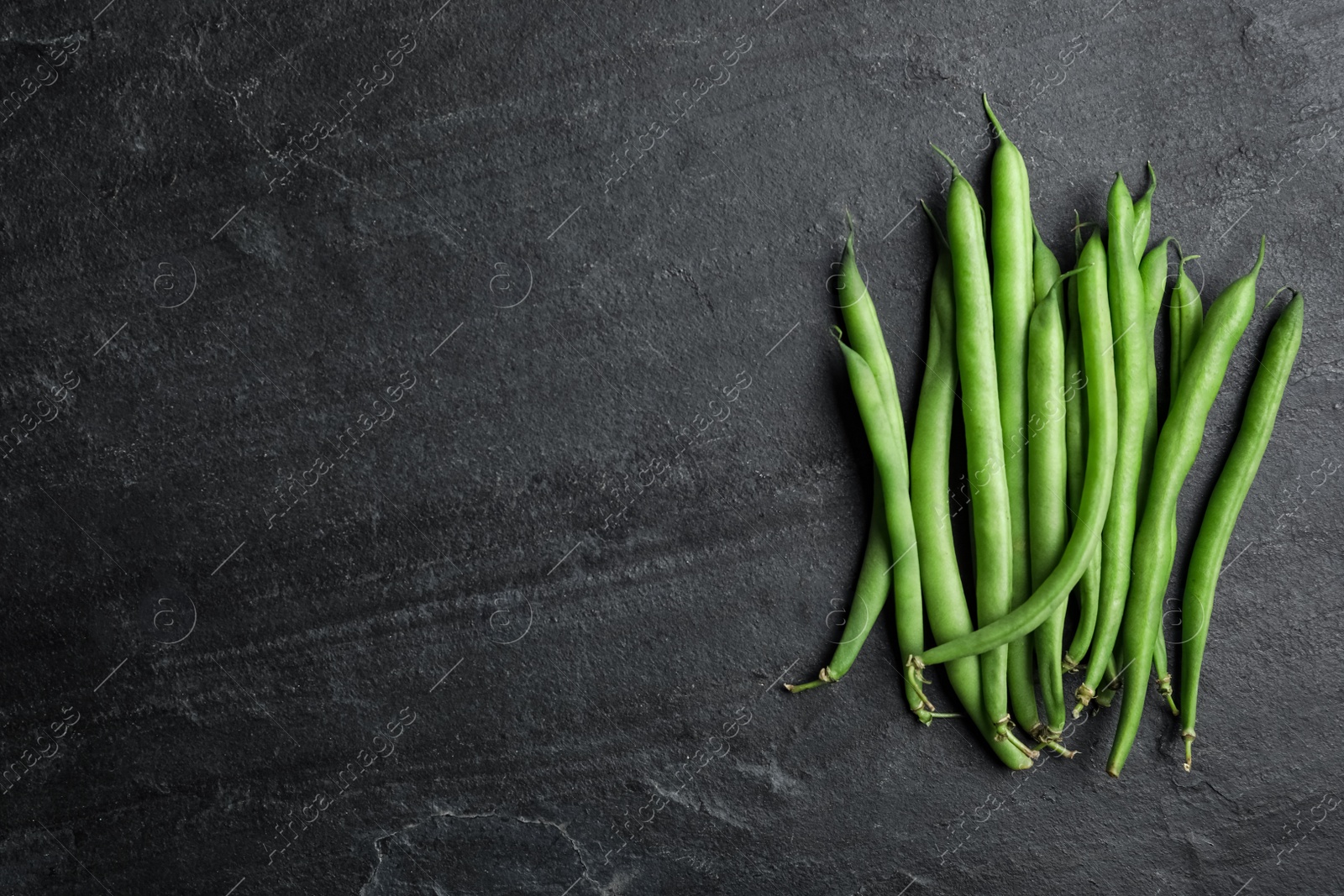 Photo of Fresh green beans on black table, flat lay. Space for text